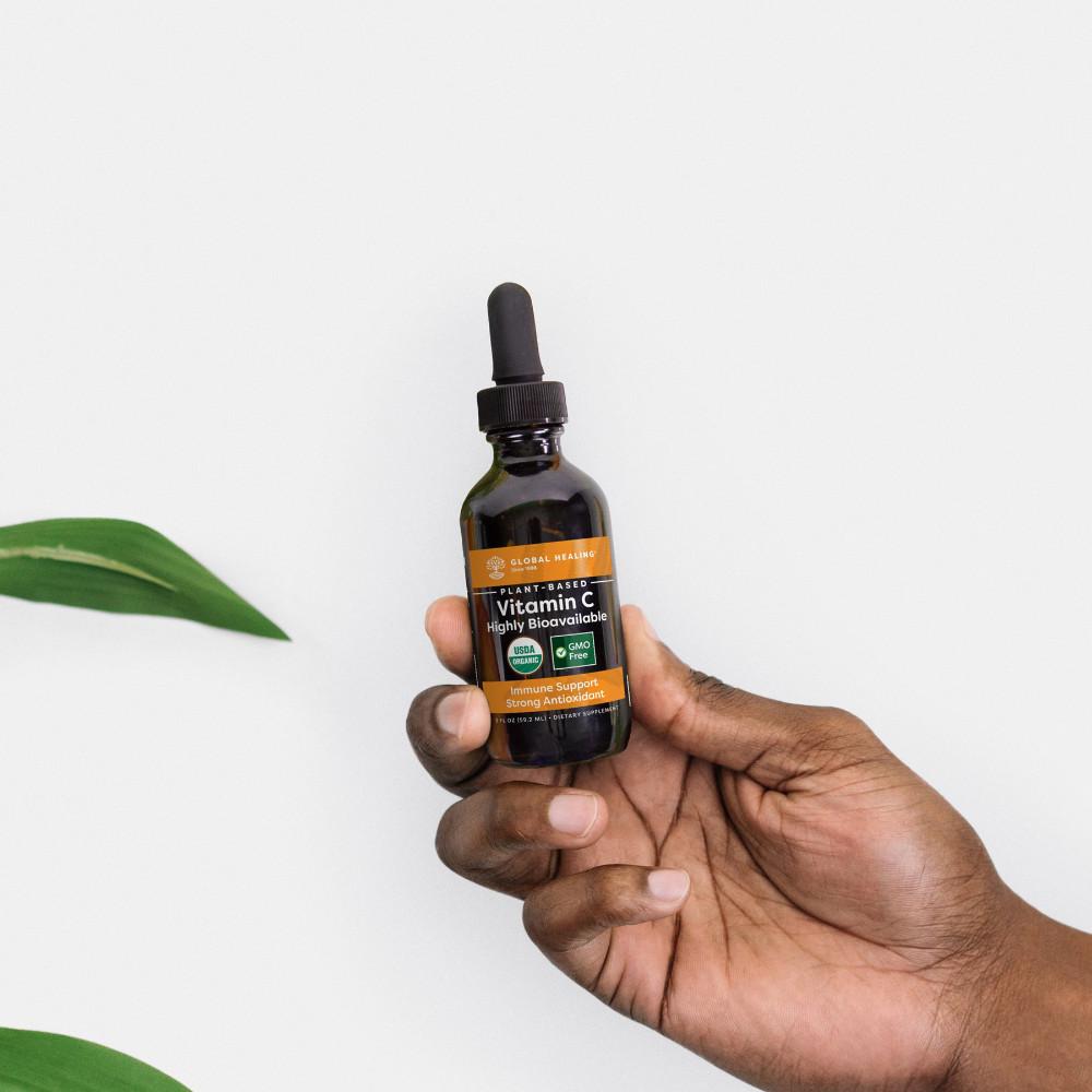 Global Healing Plant-Based Vitamin C Bottle 2oz In Hand