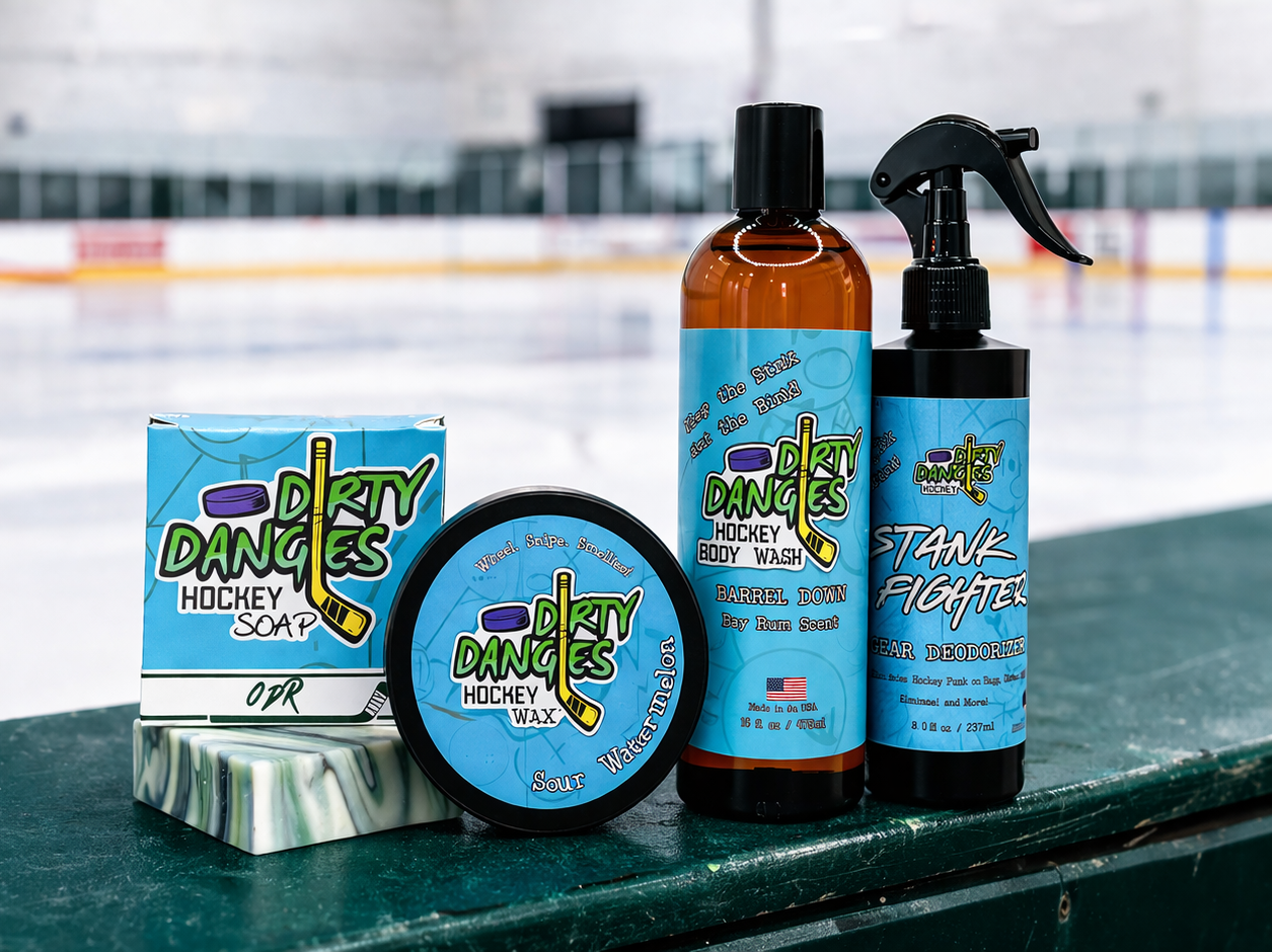 Dirty Dangles hockey soap, stick wax, body wash and gear deodorizer displayed on ice rink boards