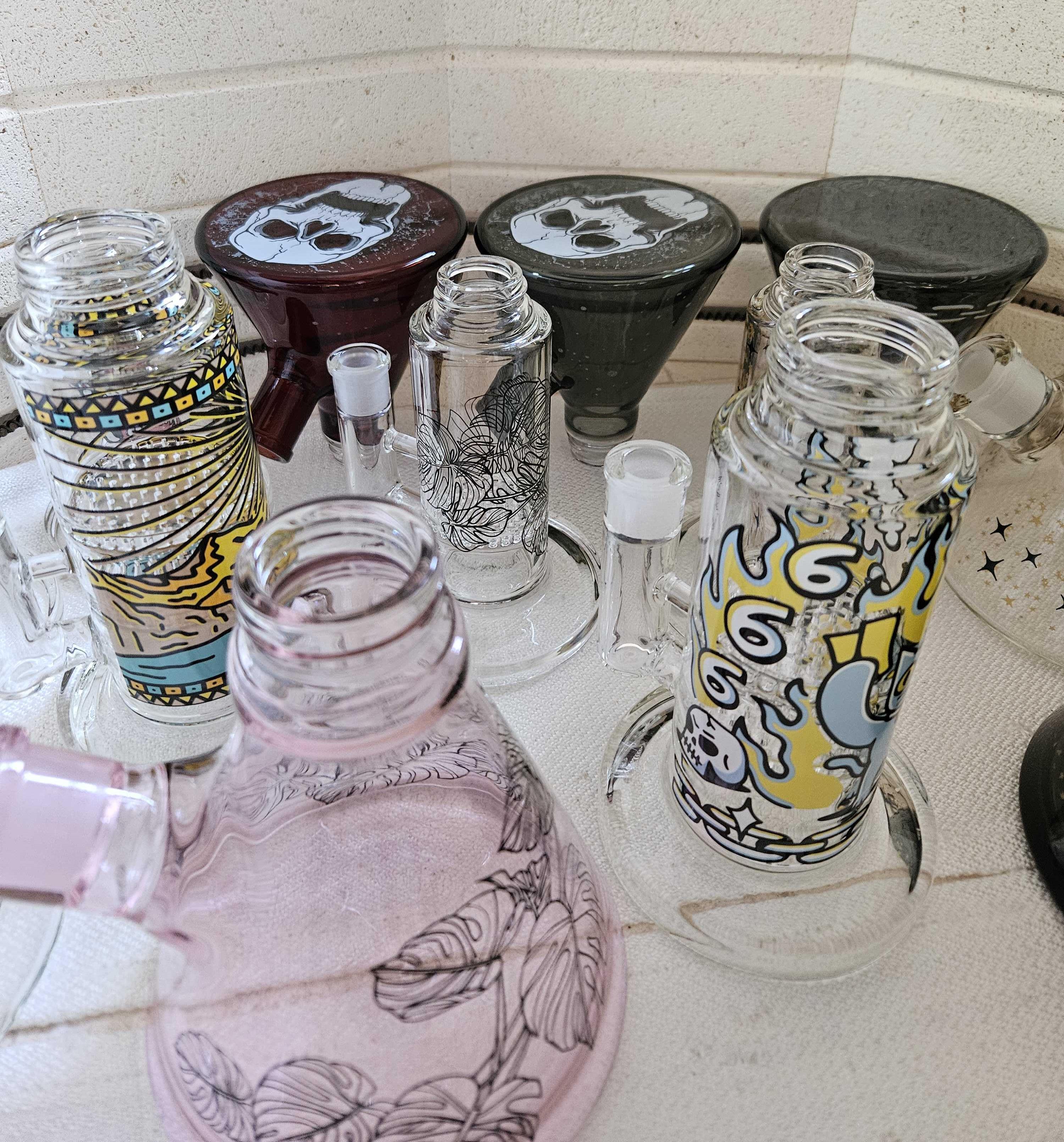 A variety of custom Prism glass bongs inside a ceramic kiln after the overnight firing process, fully bonded and ready for modular assembly and quality control.