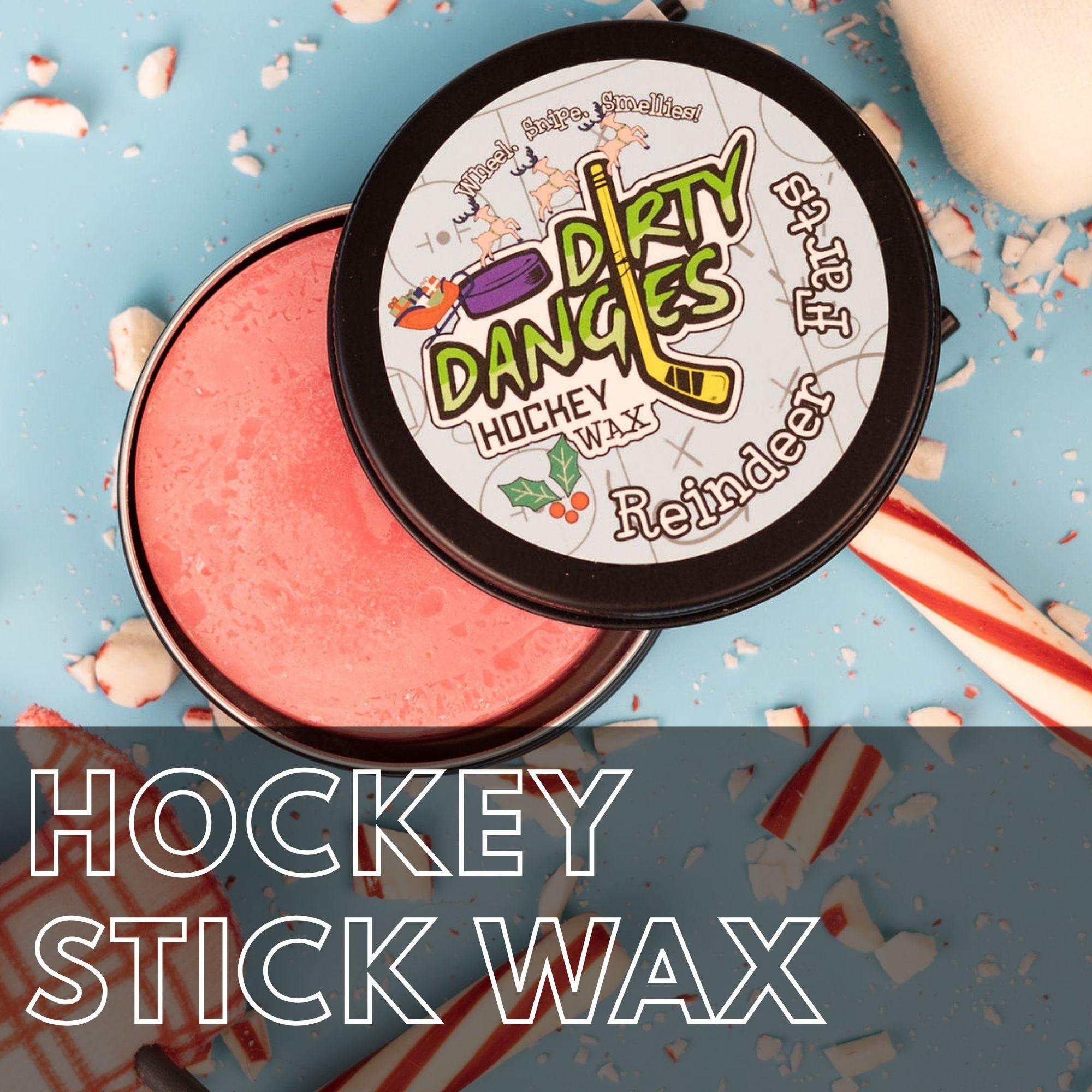 A tin of dirty dangles reindeer farts holiday hockey stick wax on a blue background with candy canes and reindeer