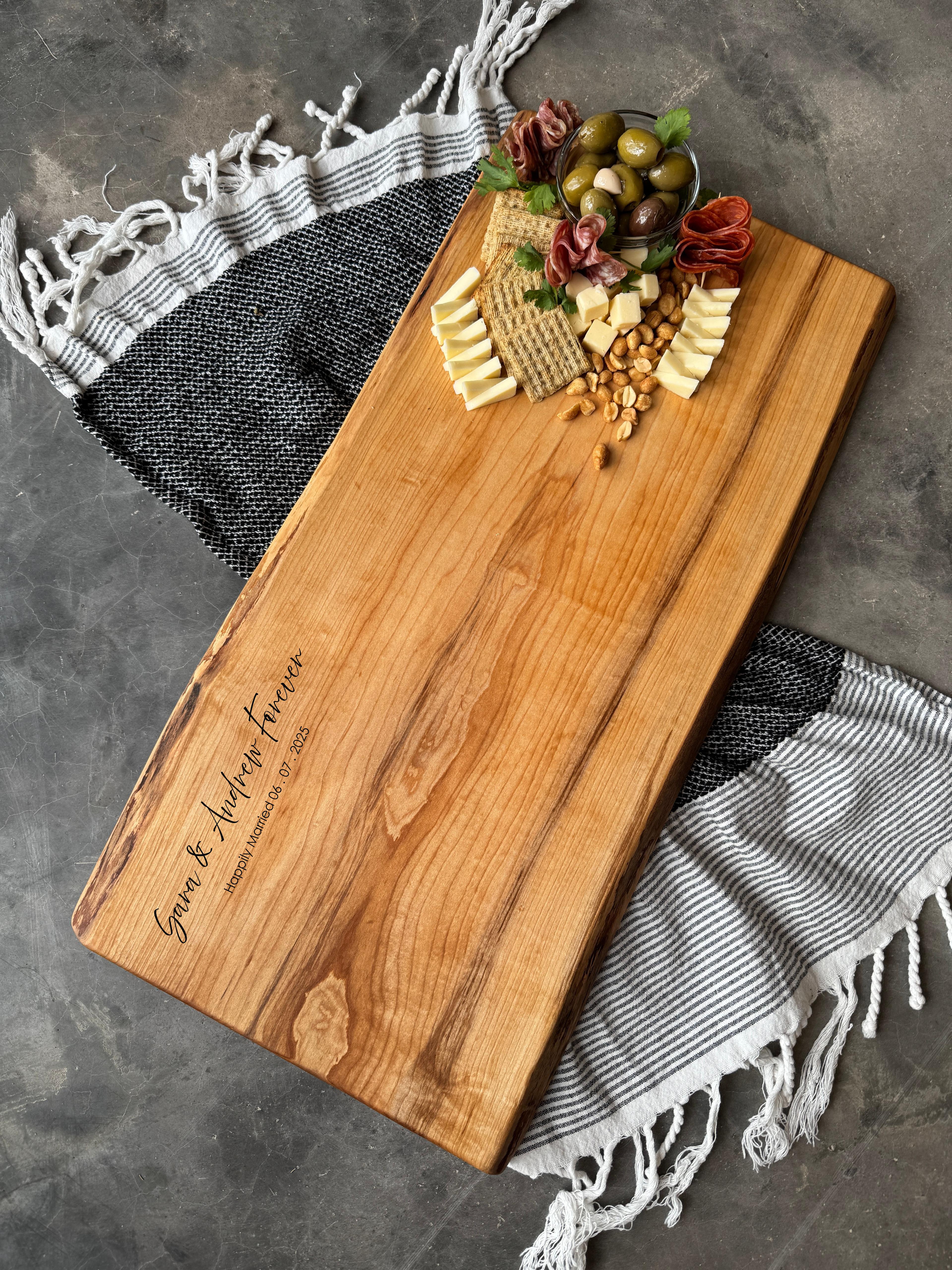 personalized live edge charcuterie board with no handles. Showing engraving on board.