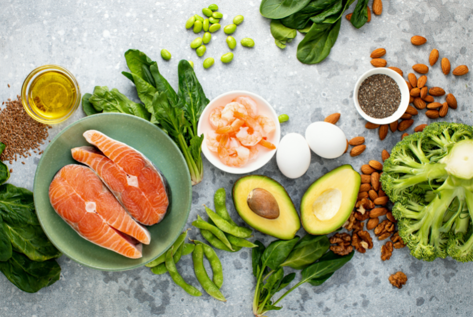 Variety of colorful foods like, salmon, avocados, olive oil and chia seeds, high in healthy fats