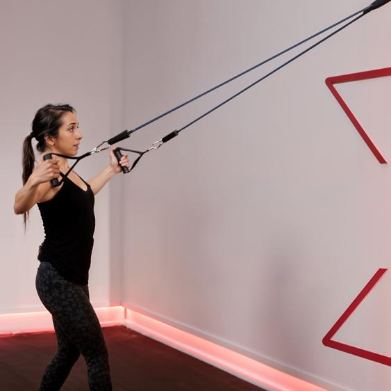 woman using xbar bar resistance system heavy duty handles