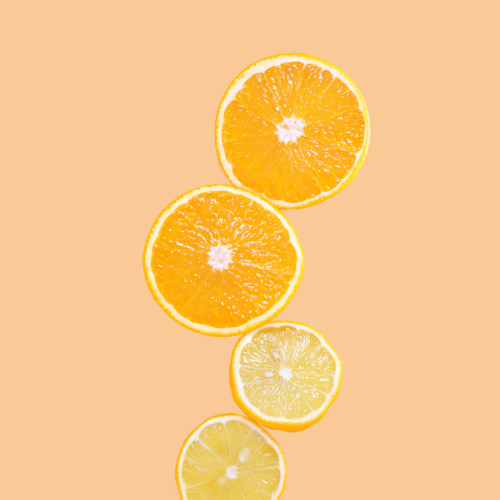 light orange background. top view of 4 sliced oranges.
