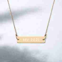 A gold necklace with writing on it