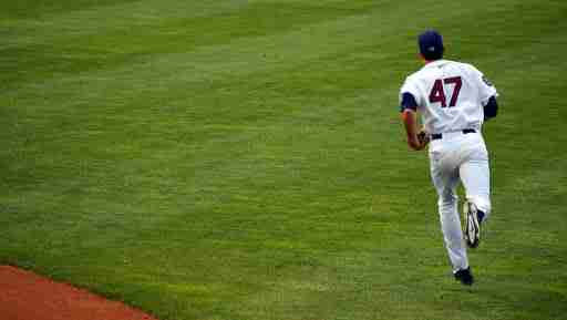 baseball player running in the outfield