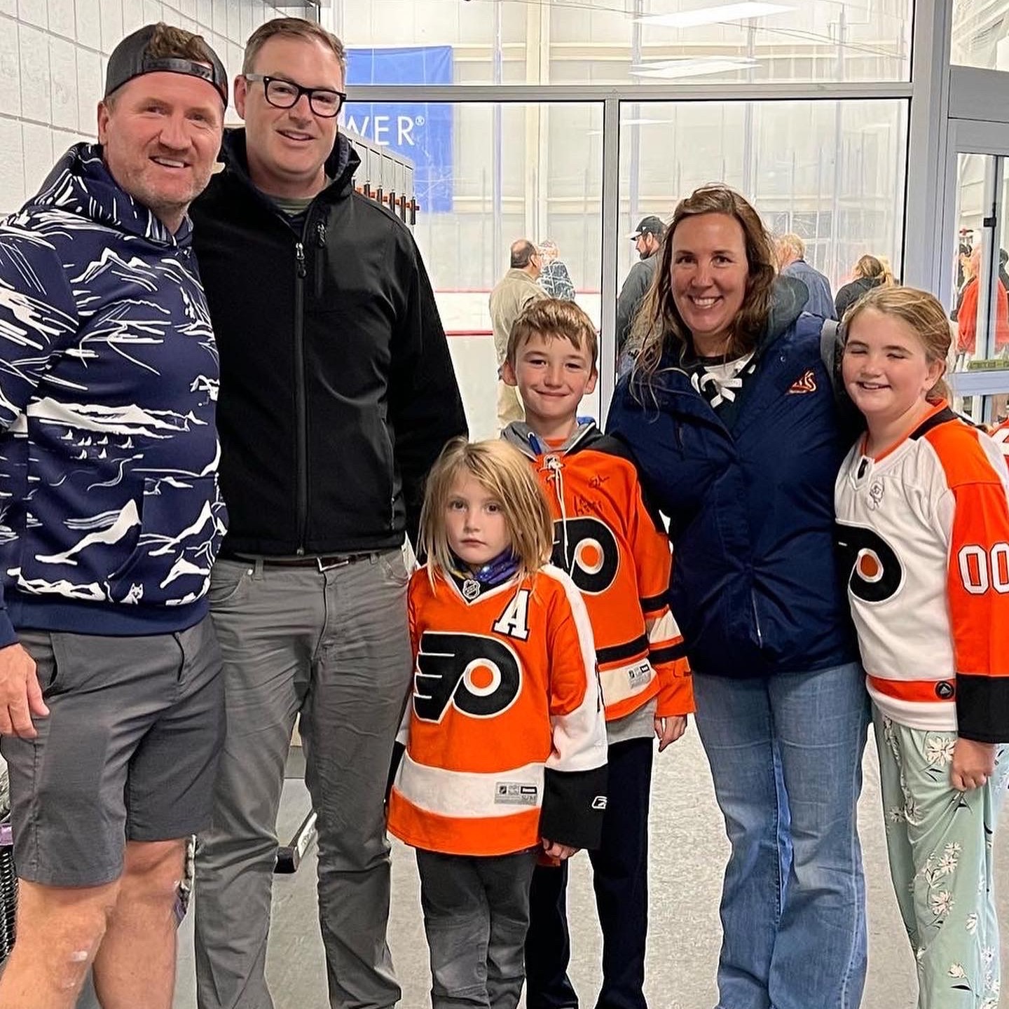Our hockey family posing with a player during spring training