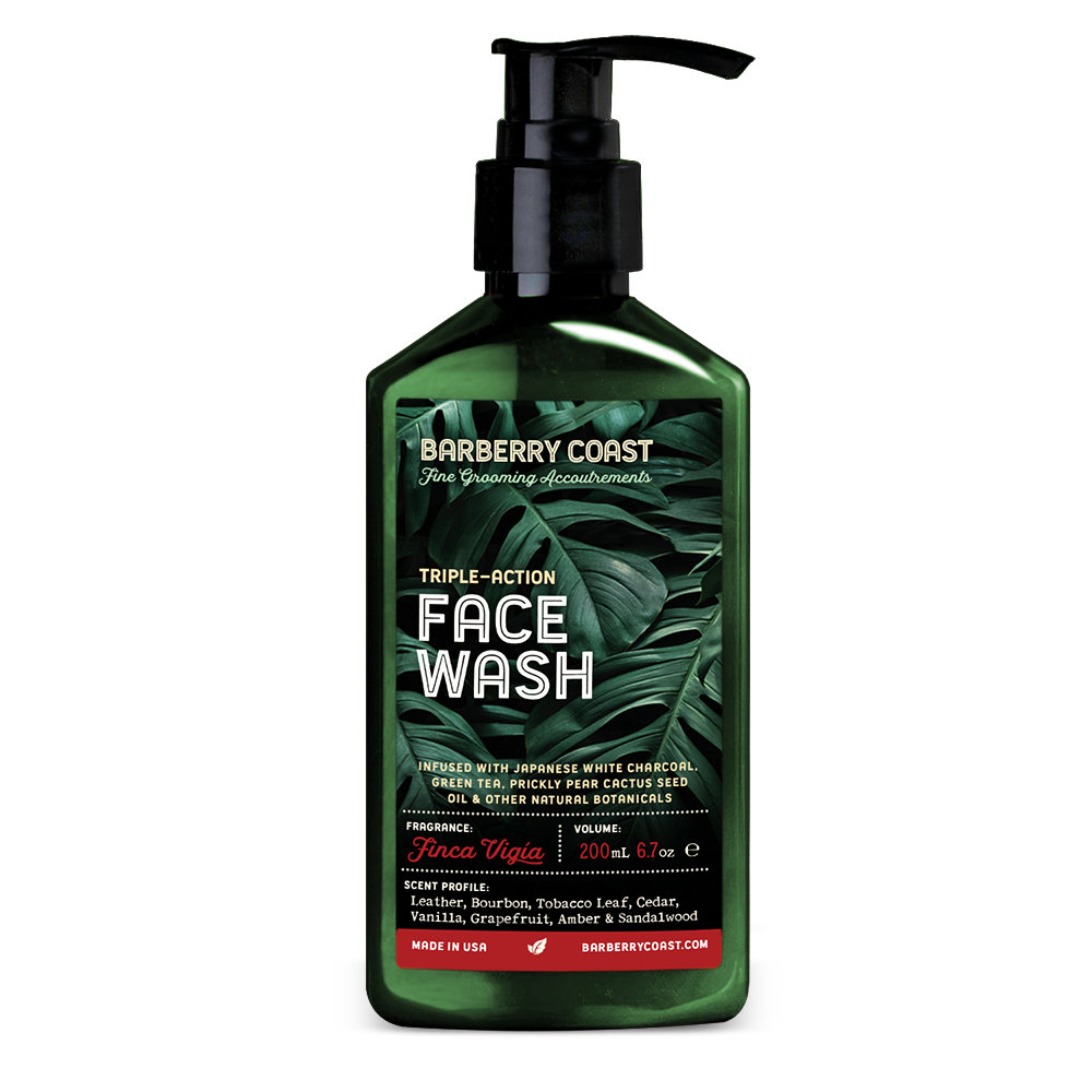 Triple-action Charcoal Face Wash Cleanser (Bay Rum) in a green pump bottle on a marble background