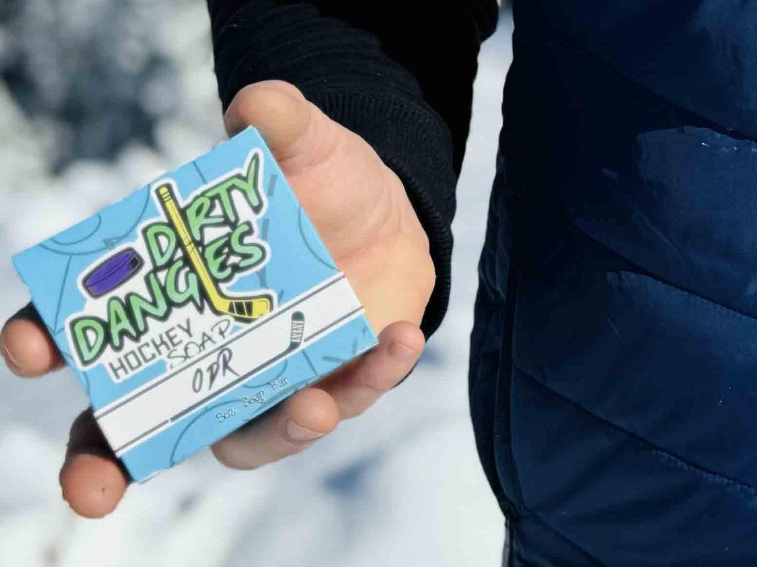A hockey player holding a box of odr hockey soap.