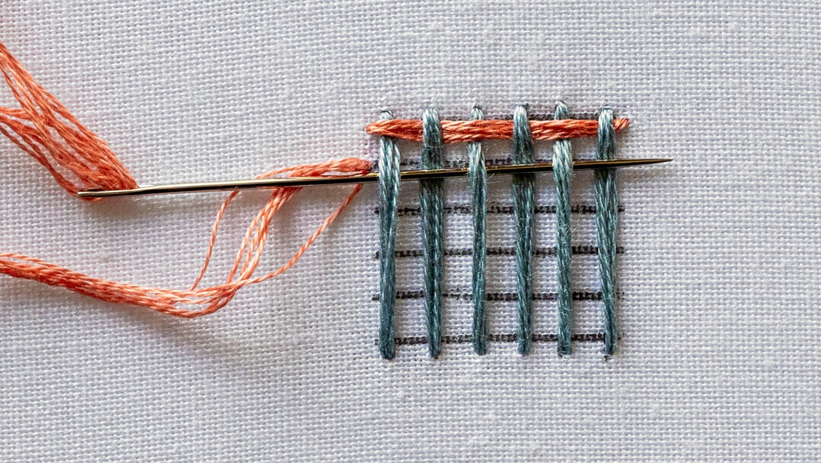 A needle coming up below the first row on the far left side.
