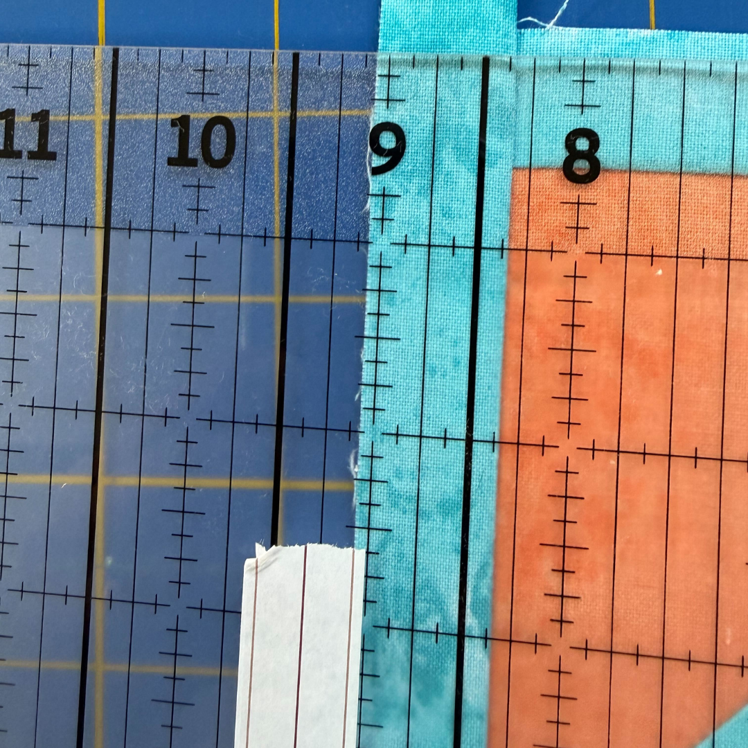 Edge of quilt block past washi tape line on the vertical side.
