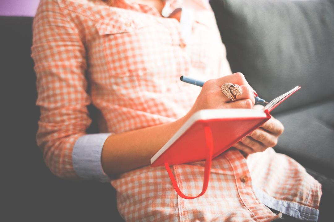 Woman writing in planner