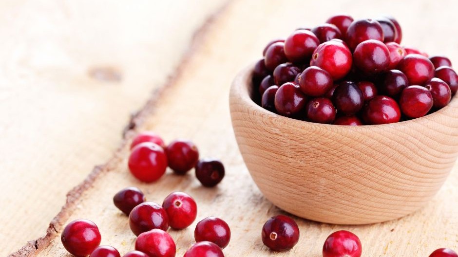 Wooden bowl of fresh cranberries