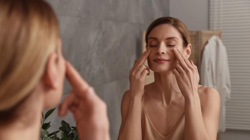 Lady doing mukhbhangya in front of her mirror