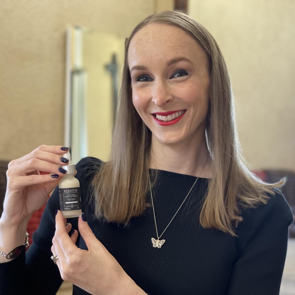 Model With Long Blond Hair Holding a Bottle of Kerotin Vitamins