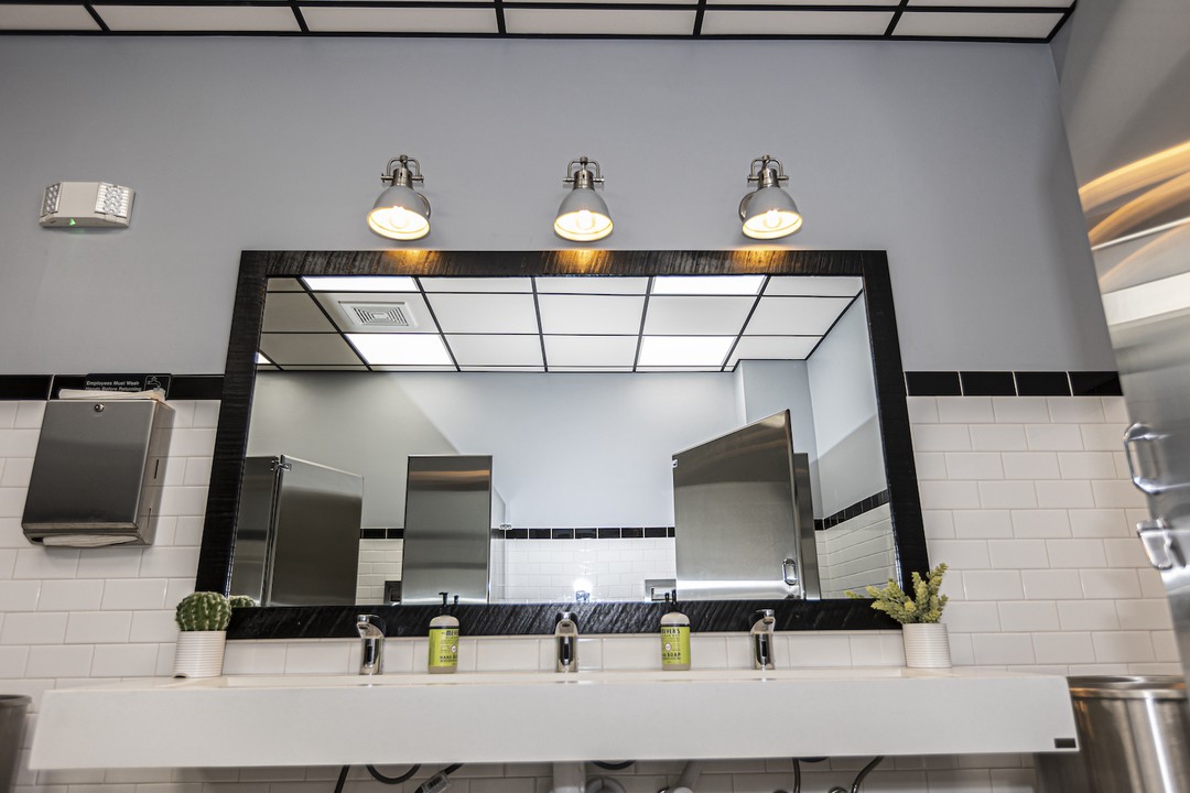 black reclaimed barnwood mirror frame restaurant bathroom