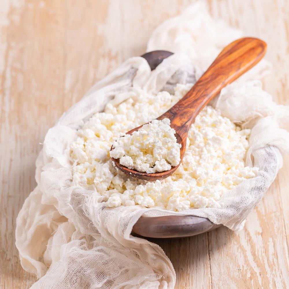Curd cheese in a bowl on kitchen table