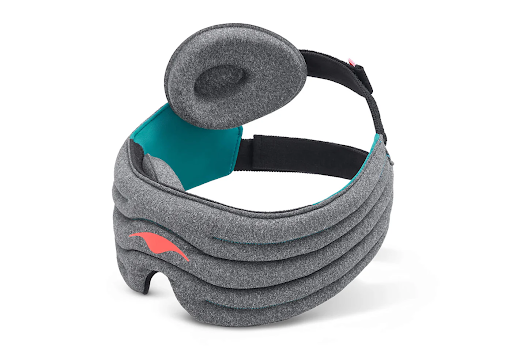 A dark gray weighted sleep mask with a duo-strap design and a detachable tapered eye cup attached to one strap.