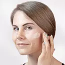 Woman applying Cerabuild Face and Neck Cream on her face