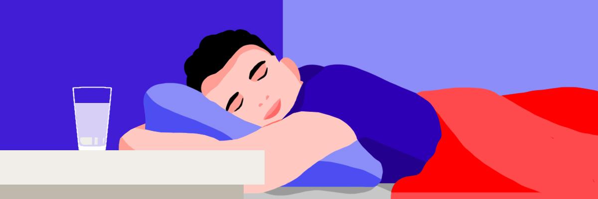 A sleeping person with a half-empty glass of milk for better sleep on his nightstand.