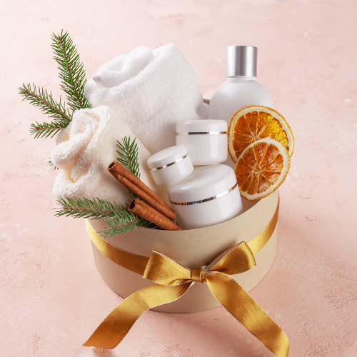 various spa items in a basket with a golden bow.