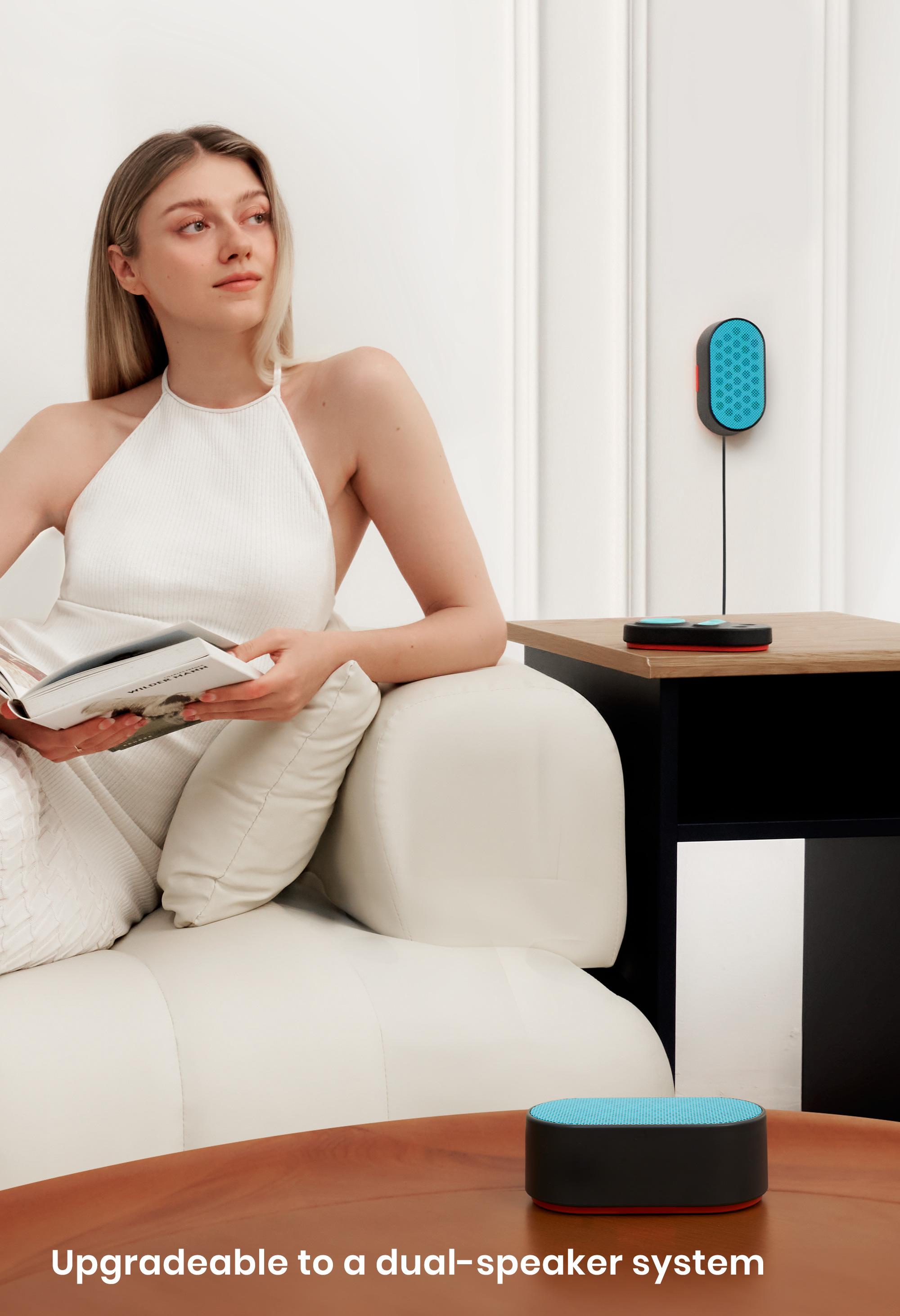 A girl sitting on a couch, listening to relaxing sounds from the best white noise machine for sleeping.