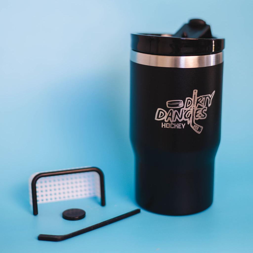 A black dirty dangles 2 in 1 drink tumbler can cooler on a blue background with a tiny hockey stick and net