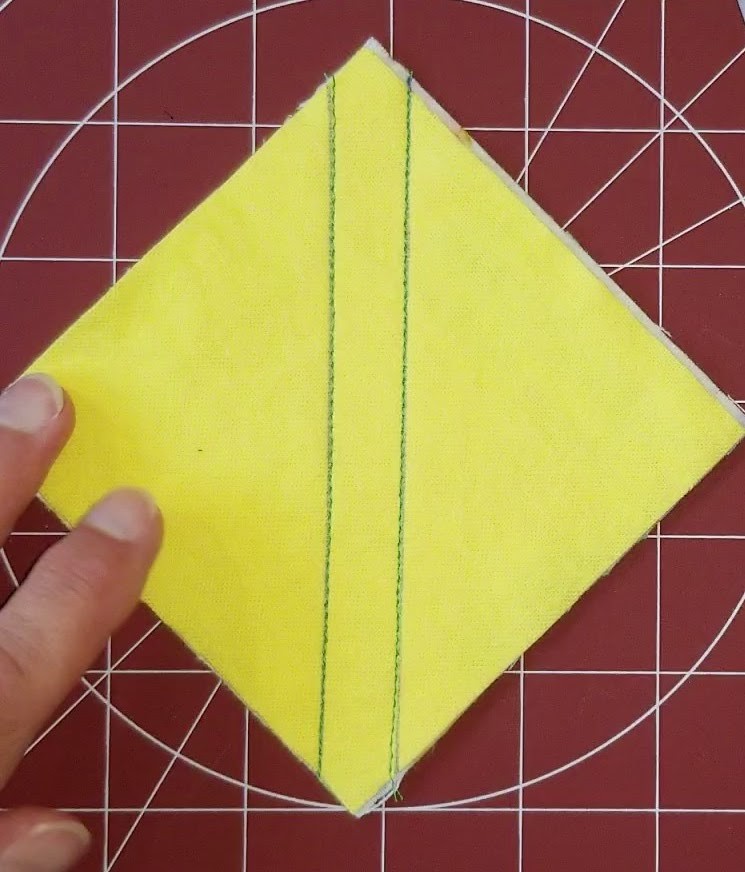 Sewn lines on fabric for Half-Square Triangle