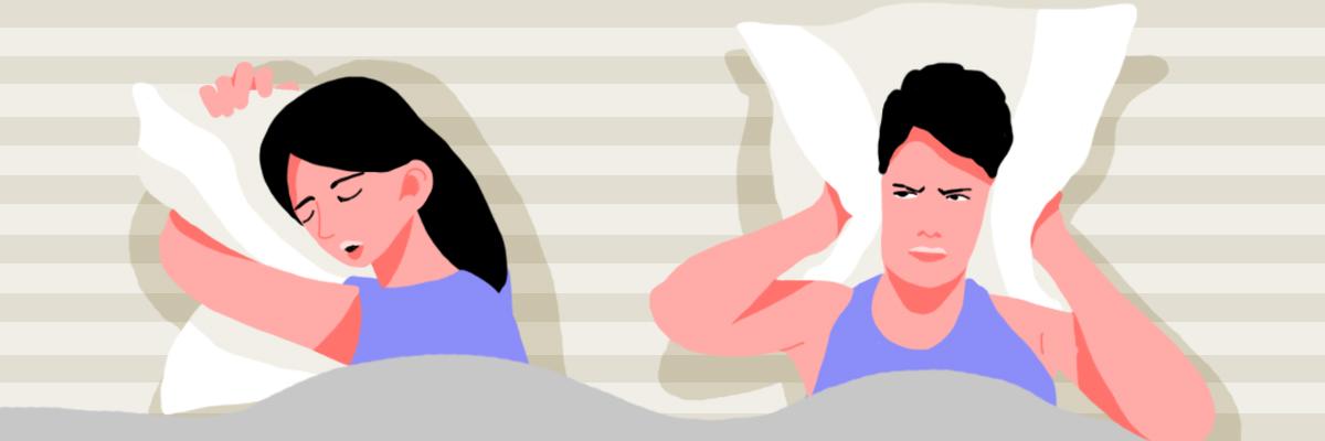 A couple sleeping together and sharing a bed. The woman is snoring loudly while the man uses a pillow to cover his ears.