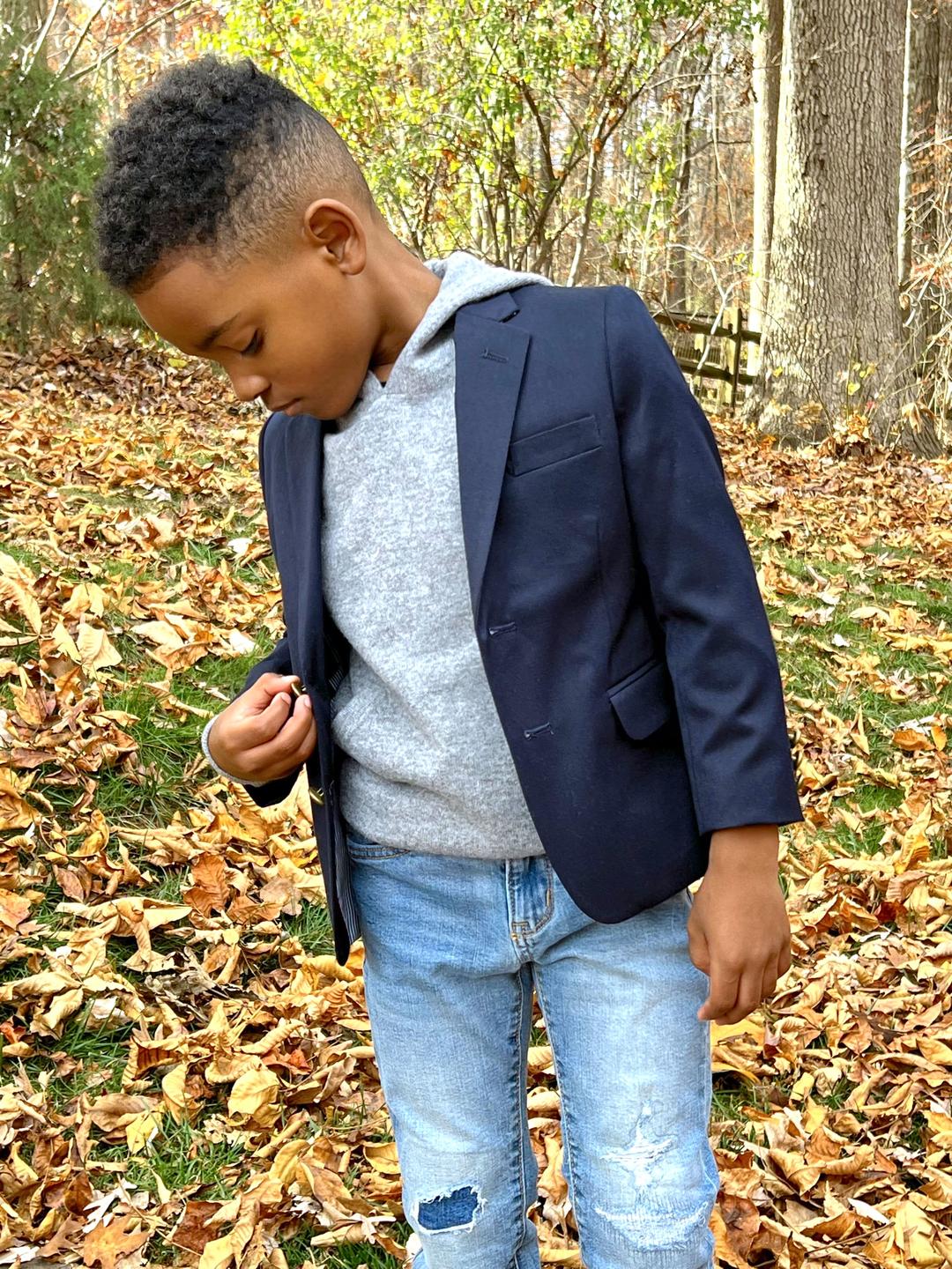 Boy wearing gray cashmere hoodie with blue jeans and blue blazer