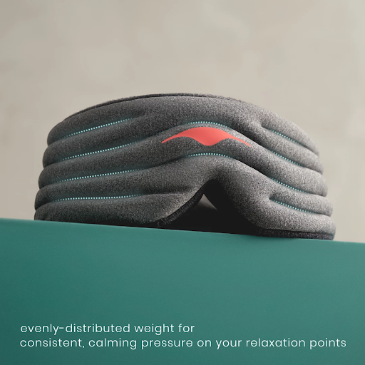 The ridged front part of a gray weighted sleep mask.
