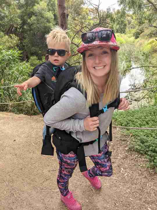 mum carrying toddler in baby carrier backpack