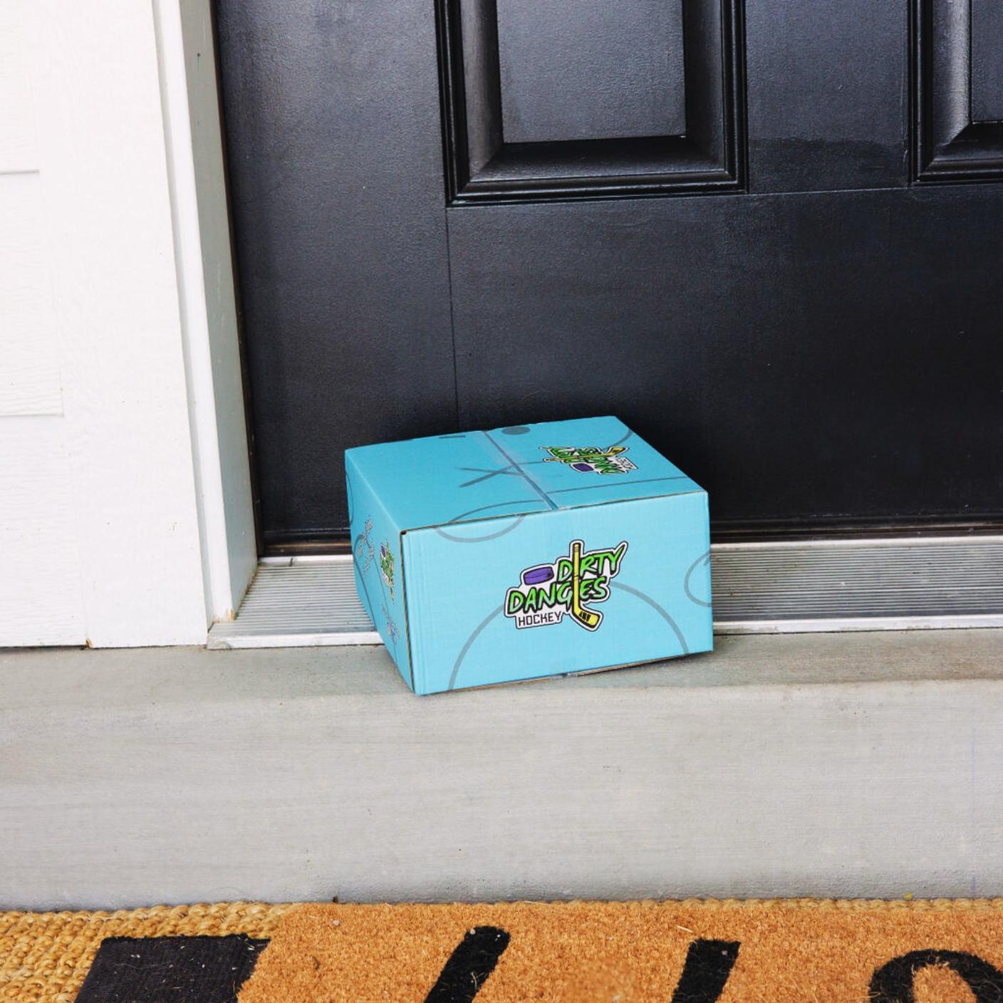 A blue dirty dangles hockey build a box on a front porch.