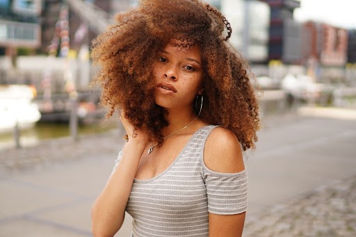 Black woman with red curly hair