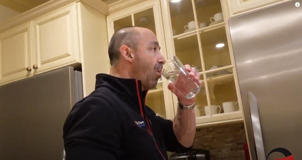 Man Drinking Water in Glass in Kitchen