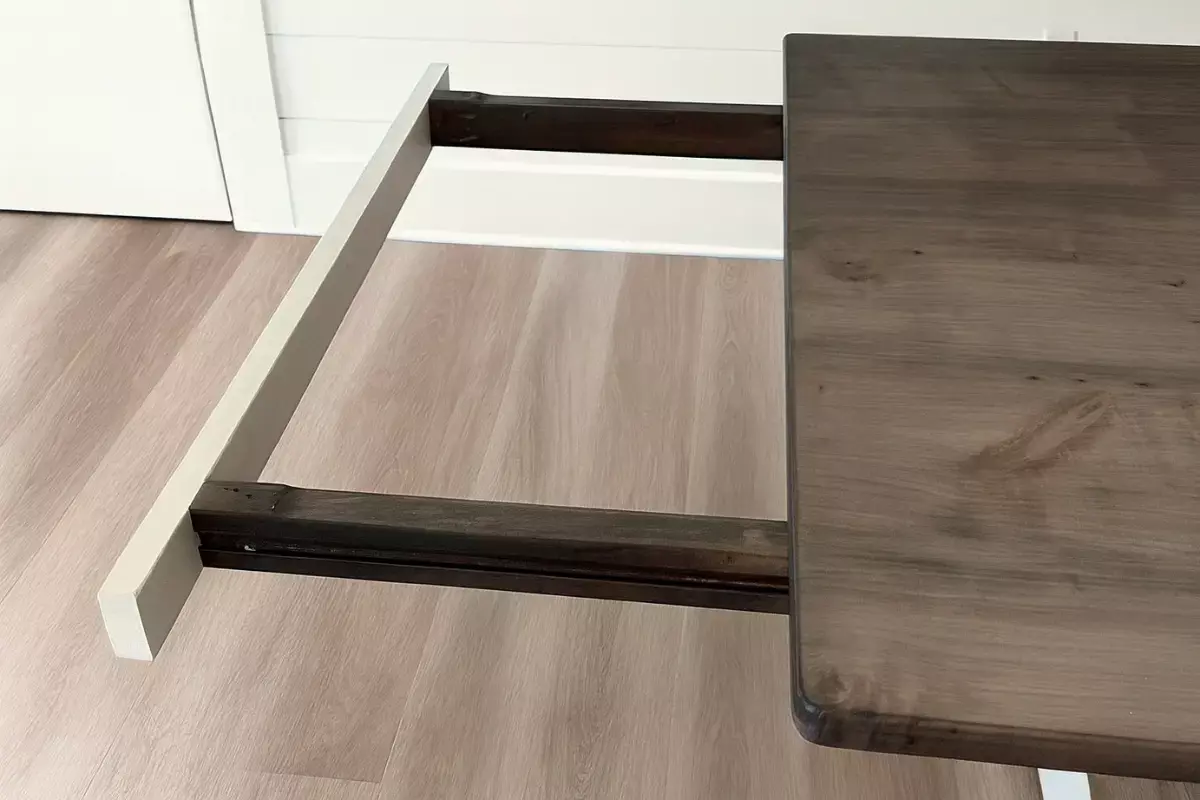 Hidden extension arm hardware supporting 18-inch leaf on custom dining table