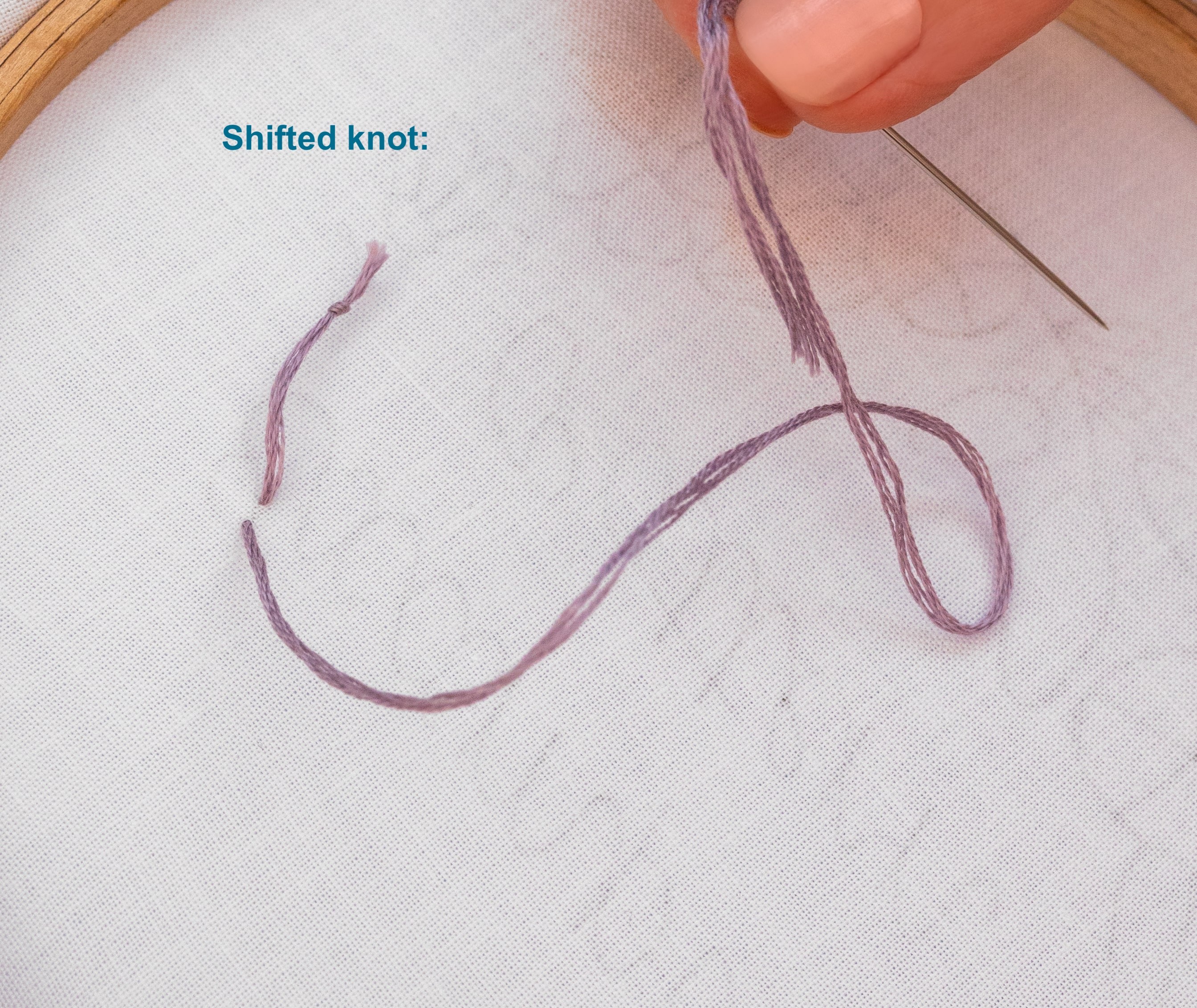 This is an image of a shifted knot at the back of an embroidery pattern.