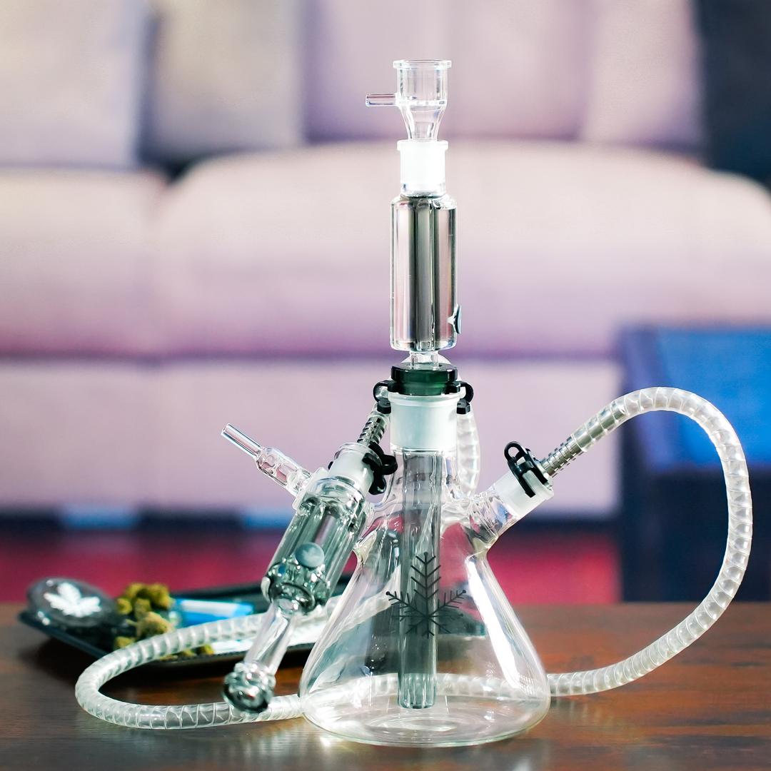 hookah bong on table next to grinder and weed