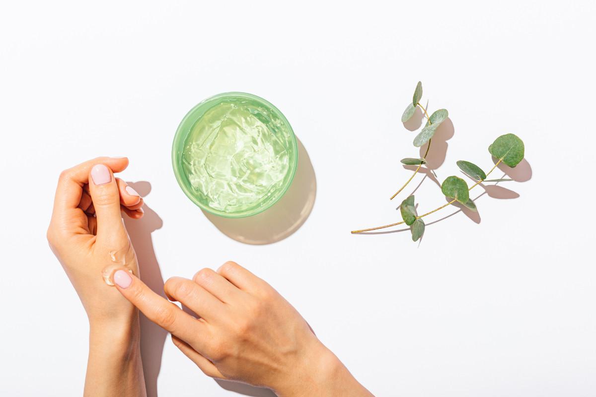 using aloe vera gel to moisturize hands.