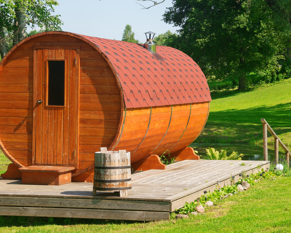 A barrel sauna in a sunny backyard .