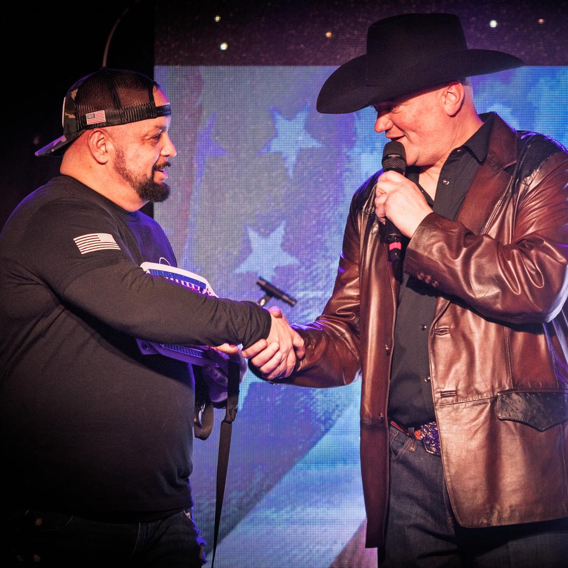 chris bingham accepts his award from jason johnson