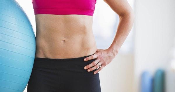 Woman Holding Exercise Ball in Gym