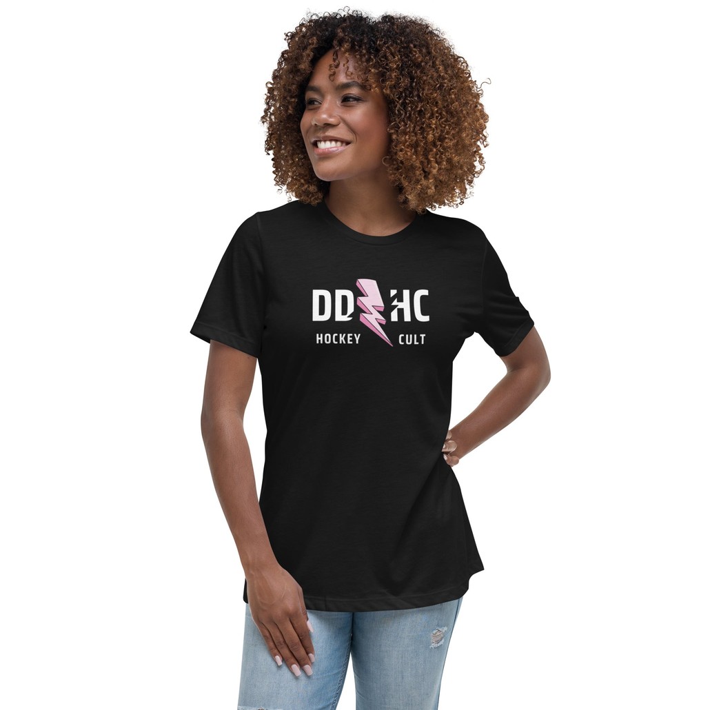 a woman wearing a black t shirt. DDHC hockey cult with a pink lightning bolt.