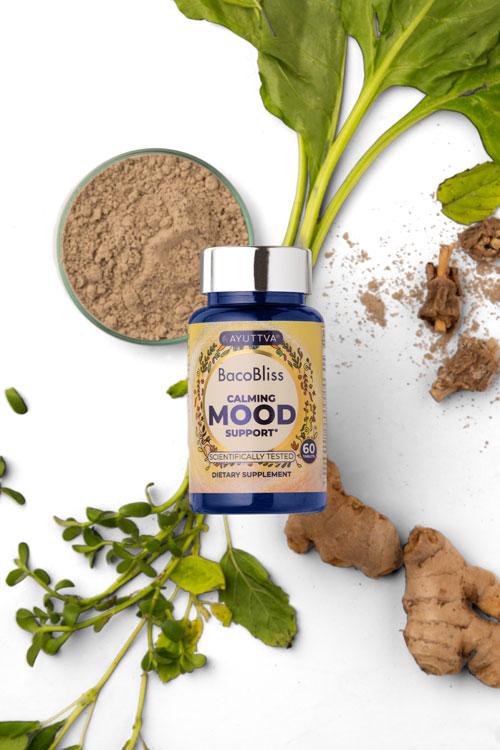 BacoBliss supplement bottle surrounded by herbal ingredients including spinach, ginger root, bacopa and basil.