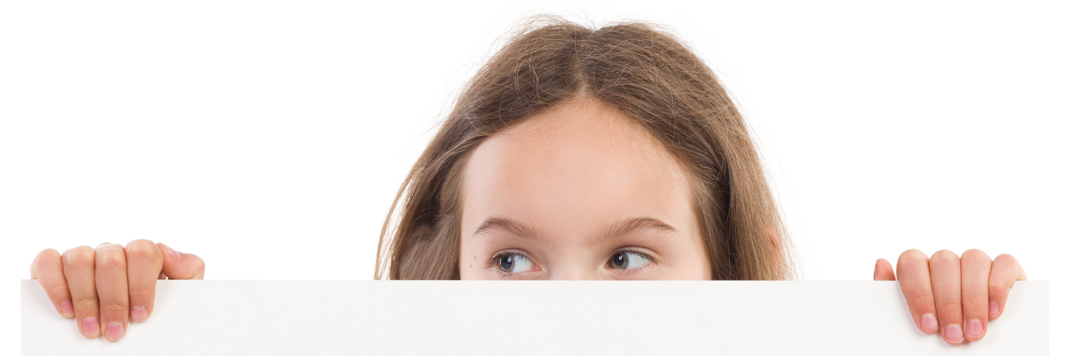 girl peeking over short wall