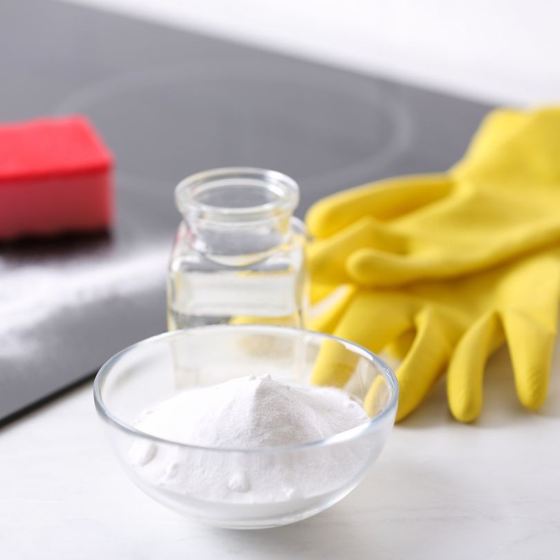 vinegar and baking soda with yellow cleaning gloves