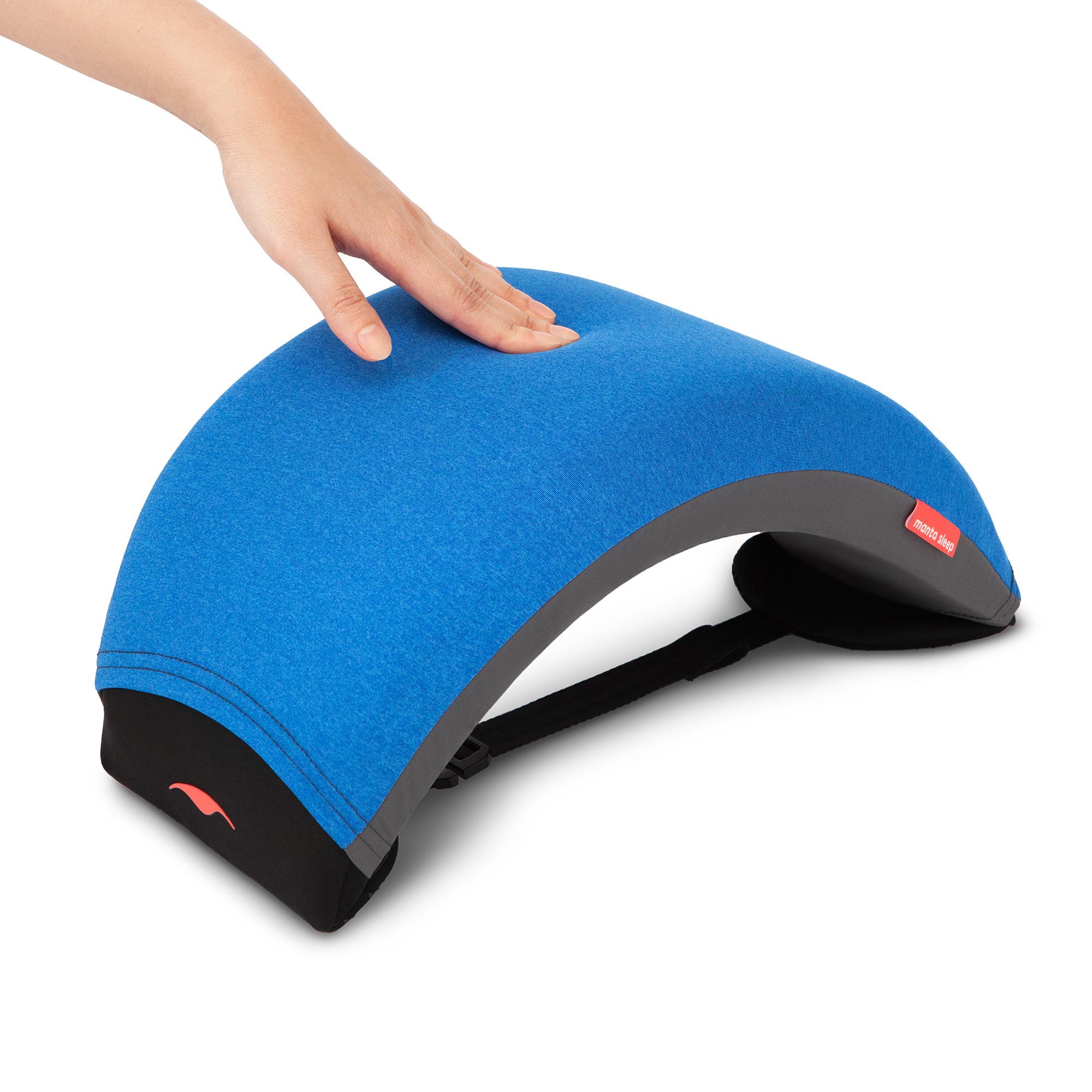 A hand pressing on the surface of a curved nap pillow.