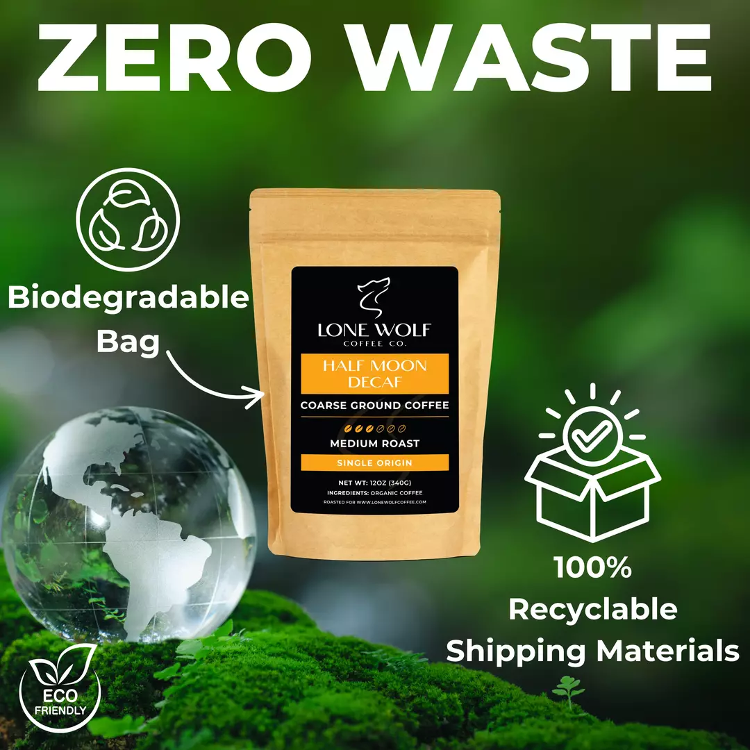Lone Wolf Coffee Half Moon Decaf Coarse Ground bag shown with biodegradable packaging and 100% recyclable shipping materials in an eco-friendly setting.
