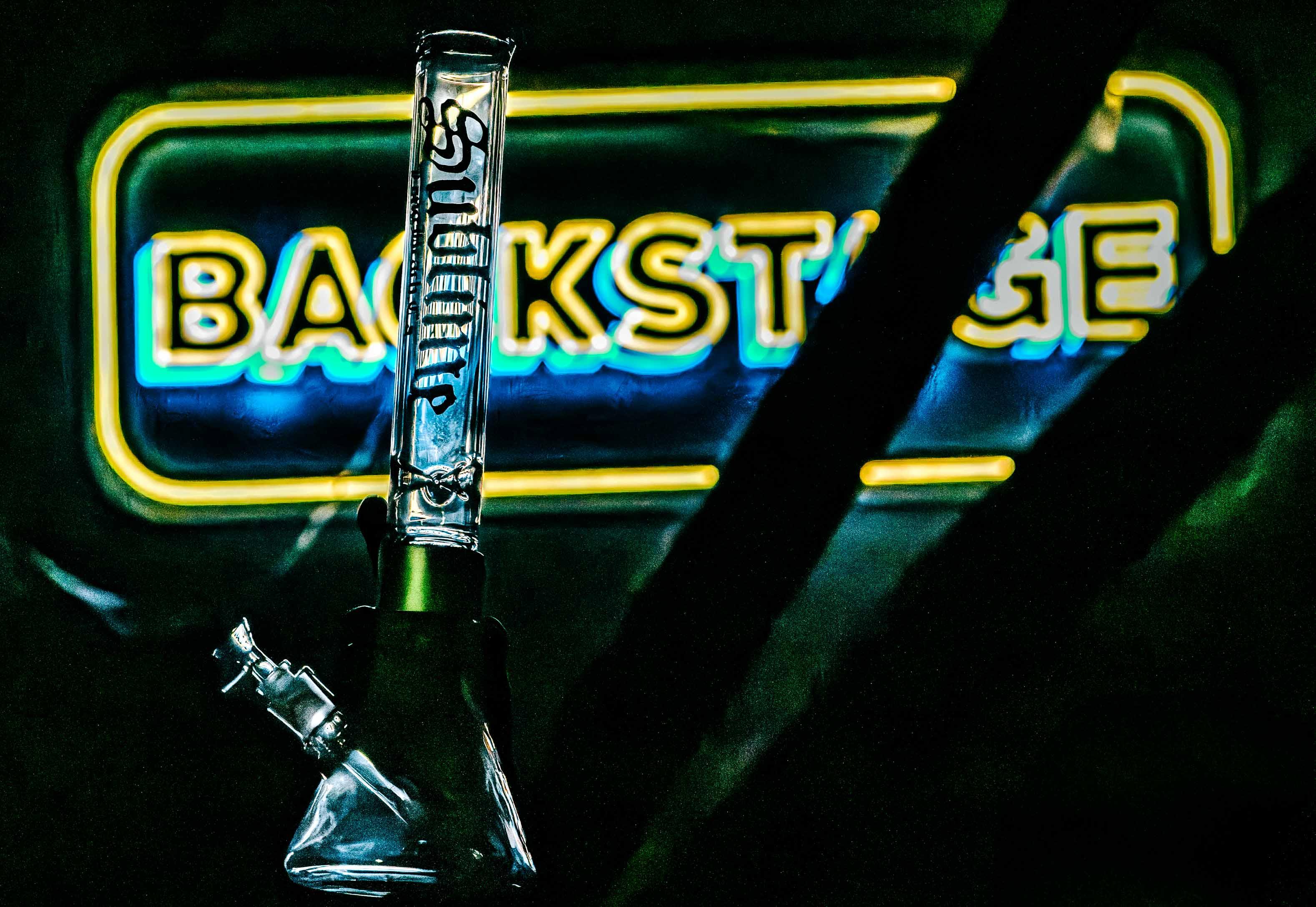 A Clear Standard Sublime x Prism modular glass bong on display in the backstage area of Red Rocks Amphitheatre. The official band collaboration piece features the iconic Sun logo, captured behind the scenes during Sublime's 2026 tour.