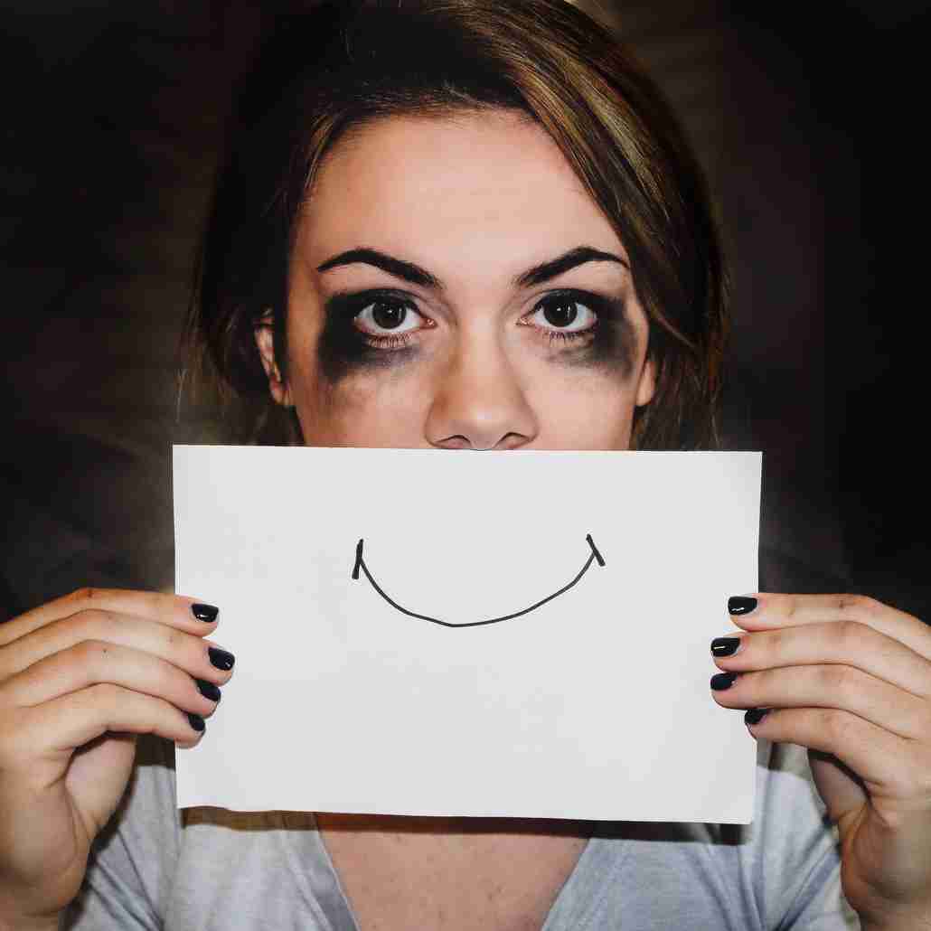 Woman Holding Smiling Face Sign